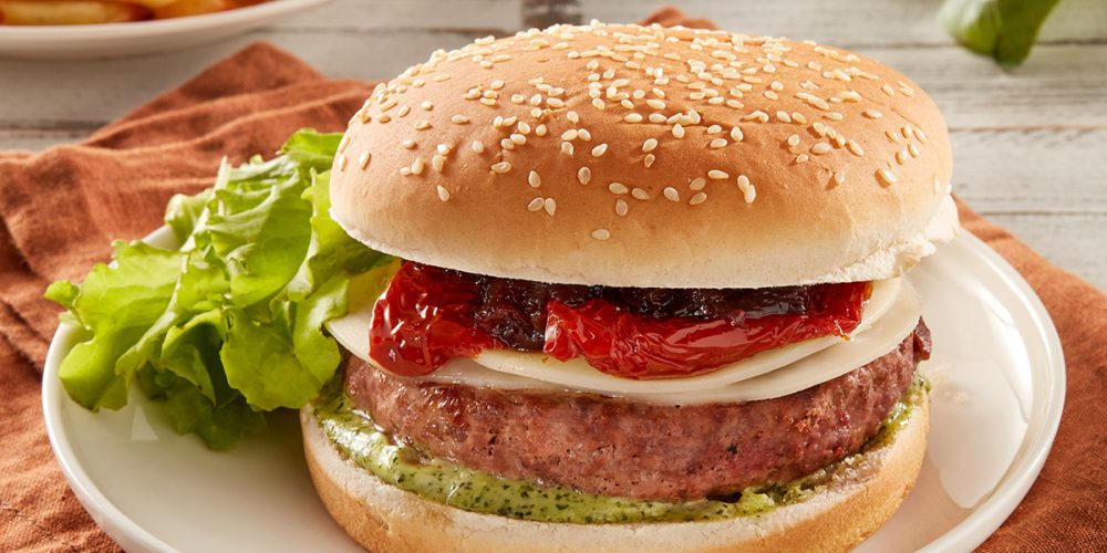 Burger with grilled peppers in oil